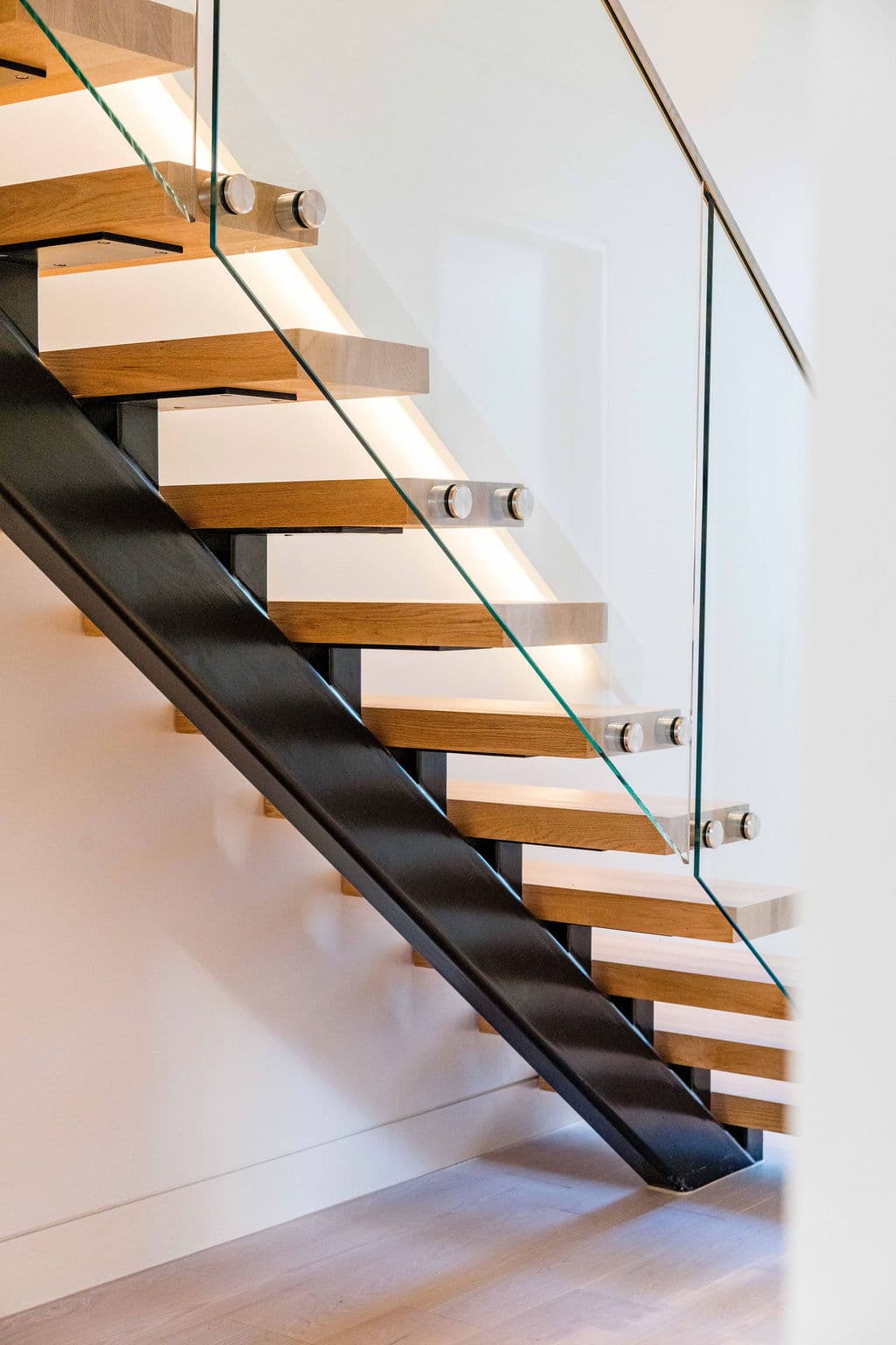 Cronulla project — floating staircase with oak treads and glass balustrade, view