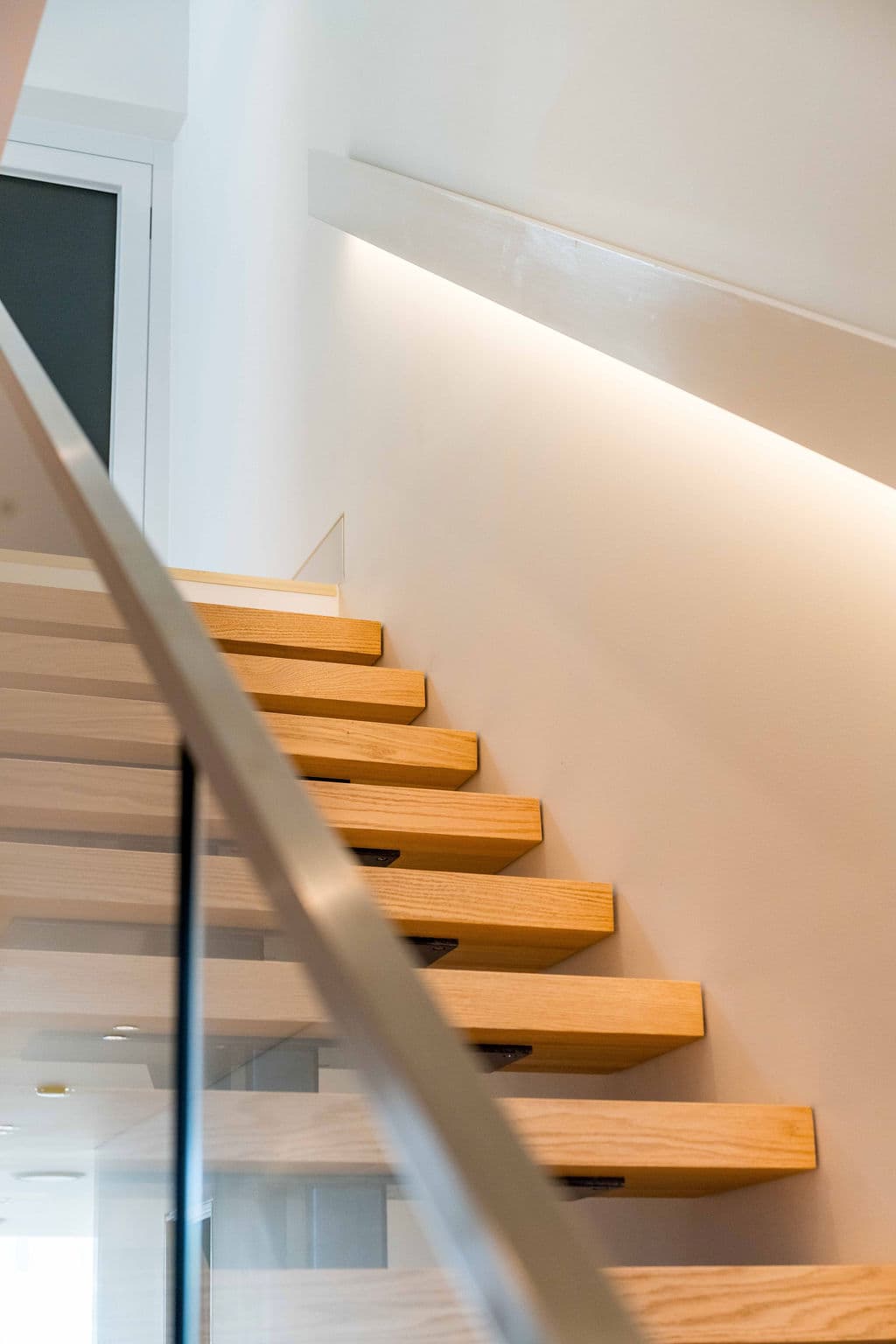 Cronulla project — floating staircase with oak treads and glass balustrade, view
