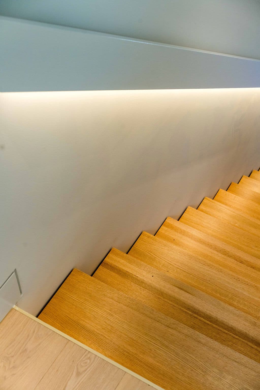 Cronulla project — floating staircase with oak treads and glass balustrade, view