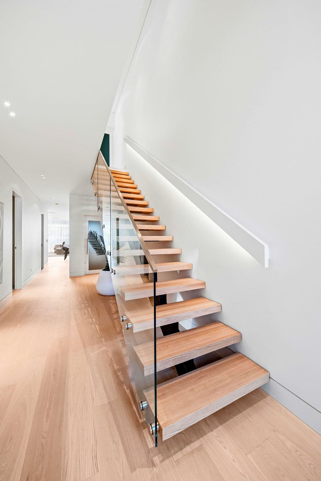 Cronulla project — floating staircase with oak treads and glass balustrade, wide view