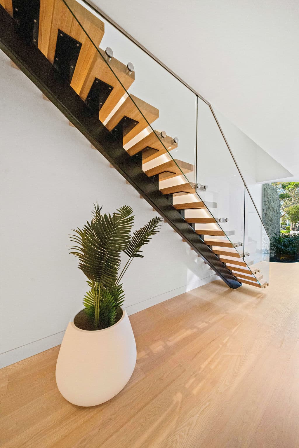 Cronulla project — floating staircase with oak treads and glass balustrade, wide view