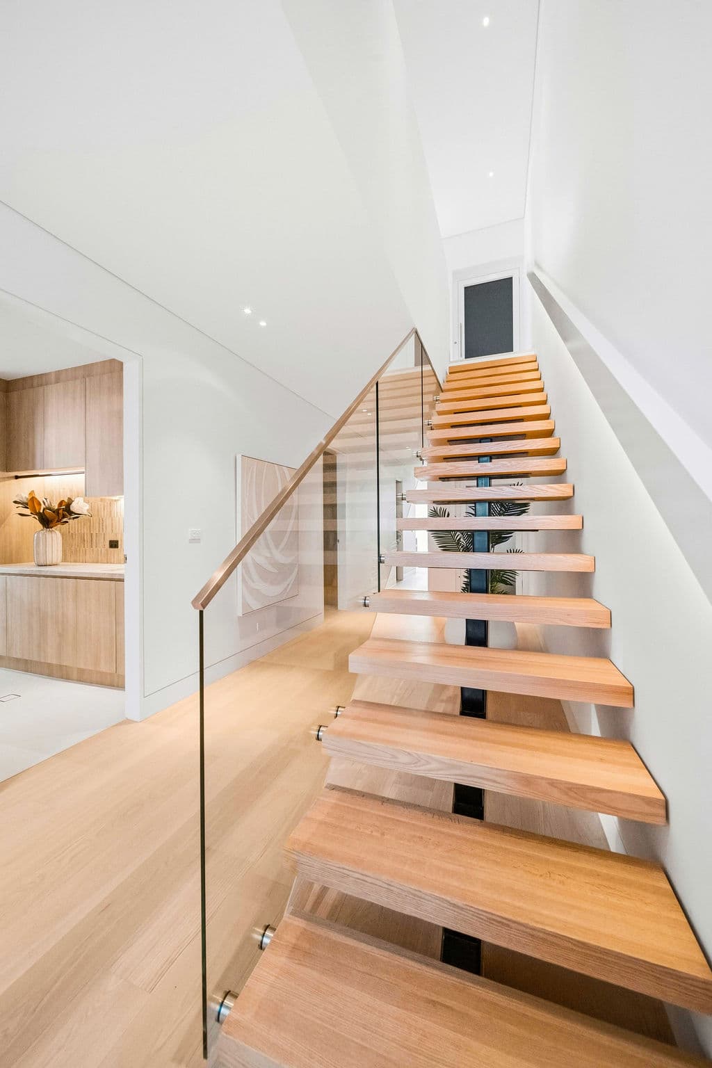 Cronulla project — floating staircase with oak treads and glass balustrade, wide view