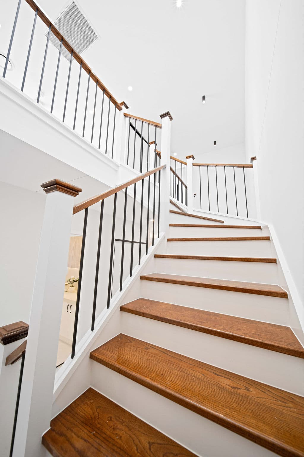 Wilton project — traditional staircase with timber treads and iron spindle balustrade, wide view